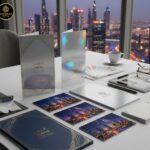 Close-up of premium postcards and menu cards with various finishes (glossy, matte, embossed) displayed on a table in a bright, modern Dubai printing studio, symbolizing high-quality printing for the restuarent and retail sectors.